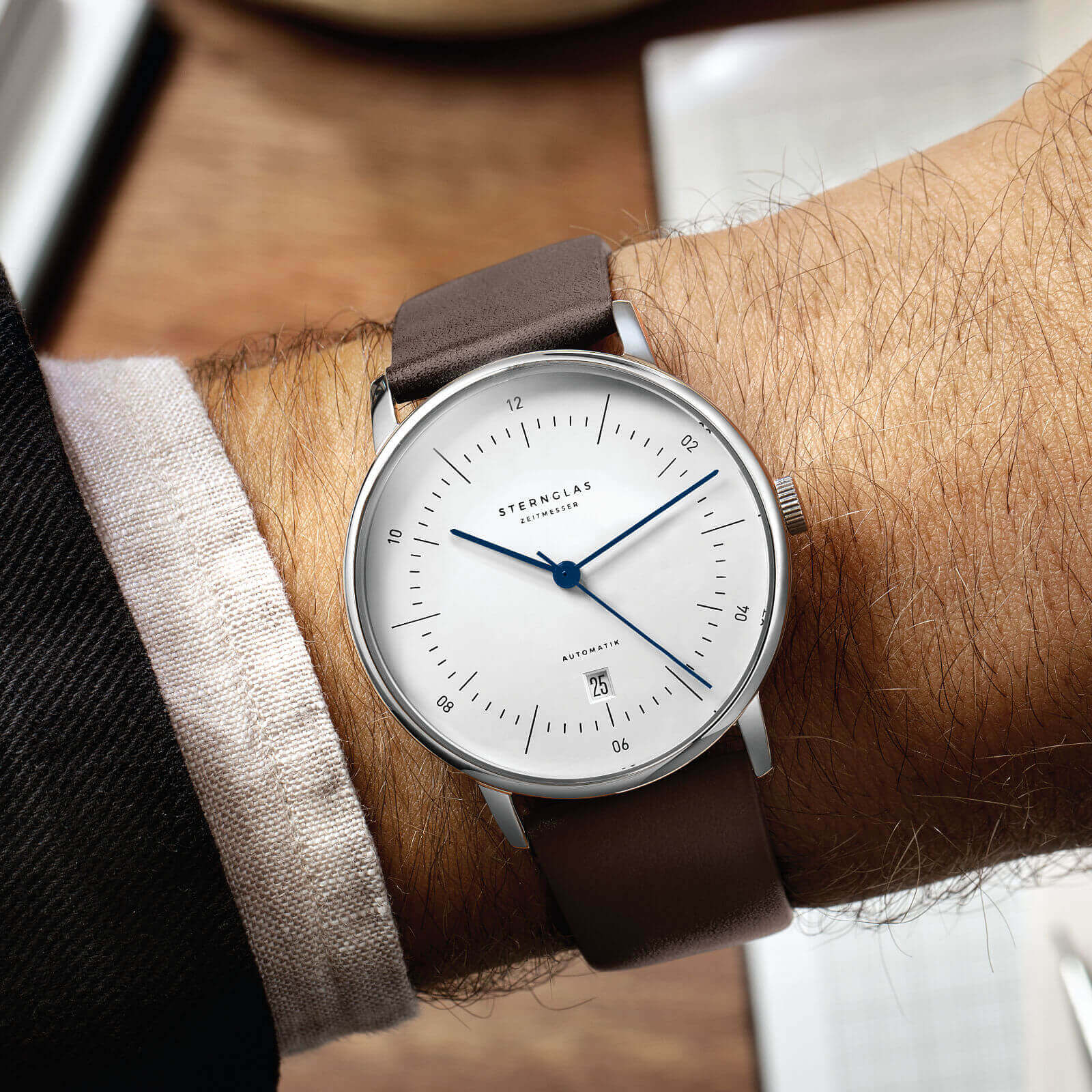 Close detail of Naos Automatik White showing dial markers and hands